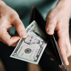 Unrecognizable man holding wallet with money